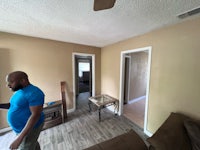 a man standing in an empty living room
