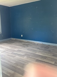 a room with blue walls and wood floors
