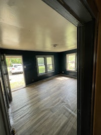 a room with hardwood floors and a doorway