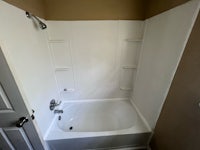 a bathroom with a bathtub and a toilet