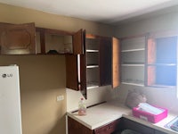a kitchen with wooden cabinets and a refrigerator