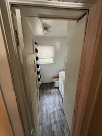 a doorway leading into a room with a wooden floor