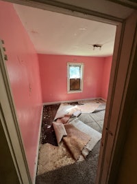 a room with pink walls and a door