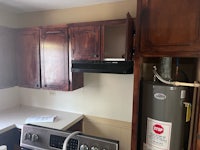a kitchen with a washer and dryer in it